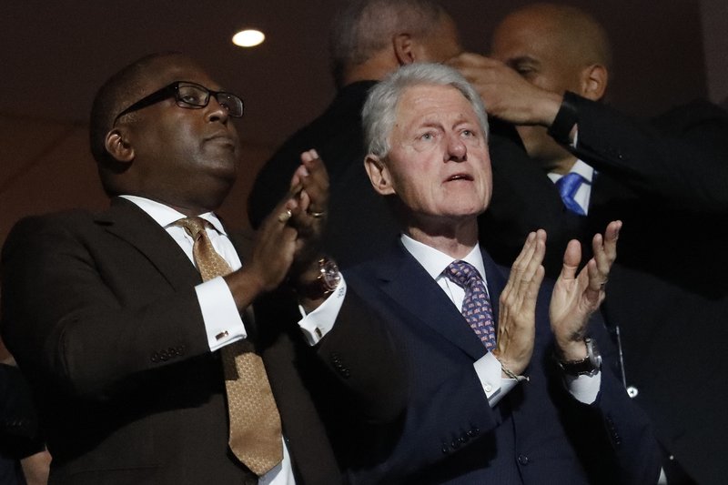 Former President Bill Clinton applauds as First Lady Michelle Obama speaks during the first day of the Democratic National Convention in Philadelphia , Monday, July 25, 2016. (AP Photo/J. Scott Applewhite)
