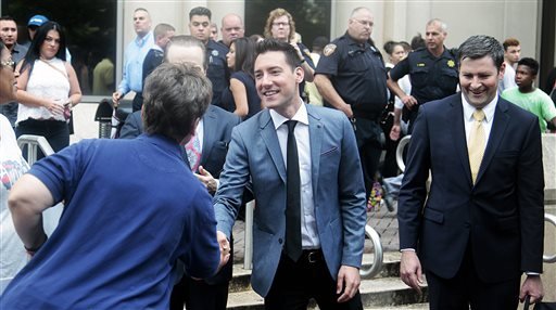 David Daleiden, center, speaks with supporters outside the Harris County Criminal Justice Center, Tuesday, July 26, 2016, in Houston.