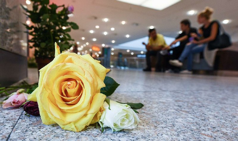 A flower is shown Tuesday in a Munich mall, four days after an 18-year-old’s shooting rampage.