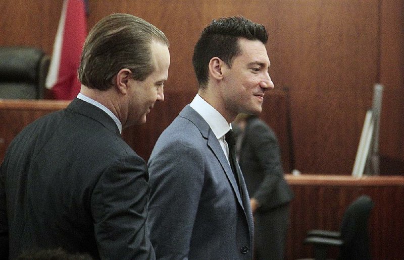 David Daleiden (right), with attorney Jared Woodfill, leaves a Houston courtroom Tuesday after prosecutors dropped charges against him and another anti-abortion activist who fi lmed undercover videos against Planned Parenthood.