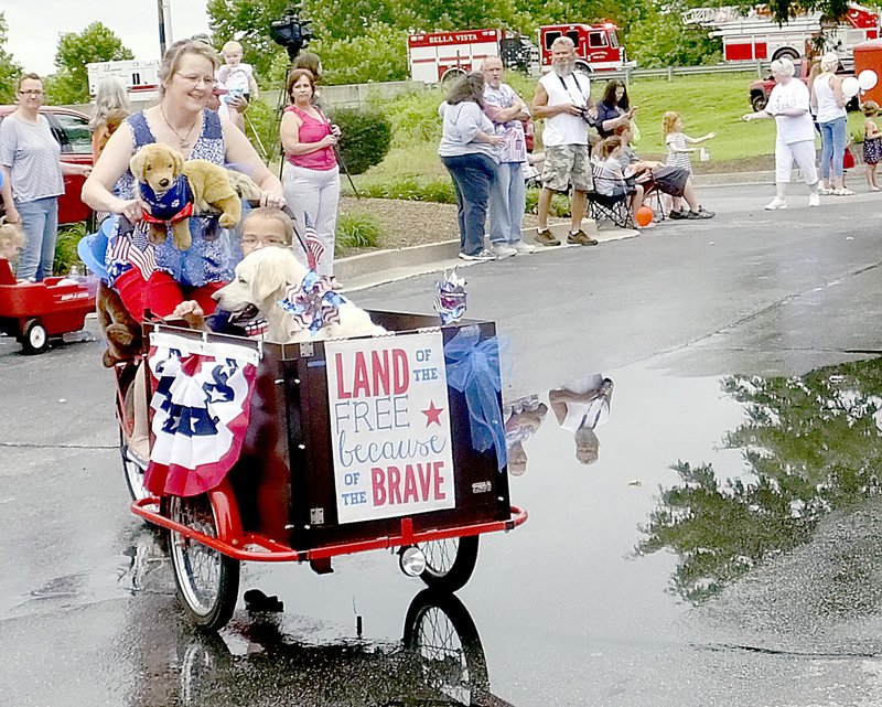 Lynn Atkins/The Weekly Vista This pedal-cart turned float was a unique float in the Bella Vista Patriots Parade.