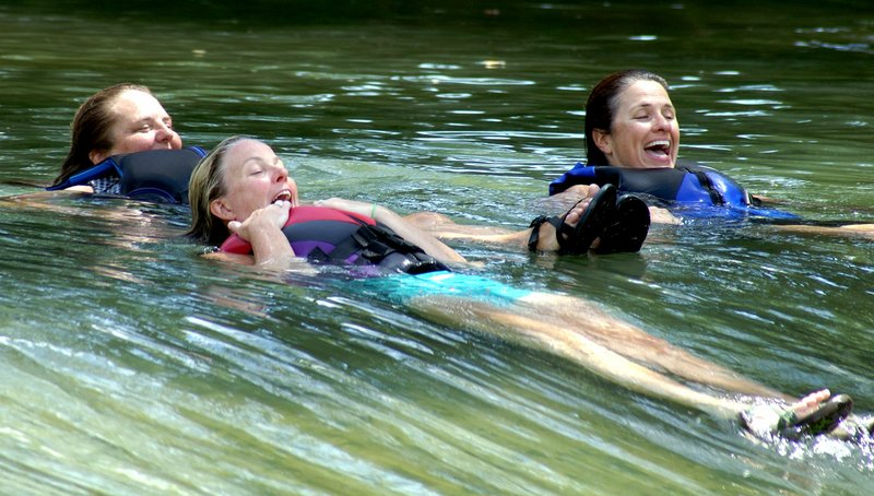 Photo by Randy Moll Robyn Nolen (left), Kerri Vollmer and Amy Witte floated over the rapids at the Siloam Springs Kayak Park on the Illinois River Thursday, July 21, 2016.