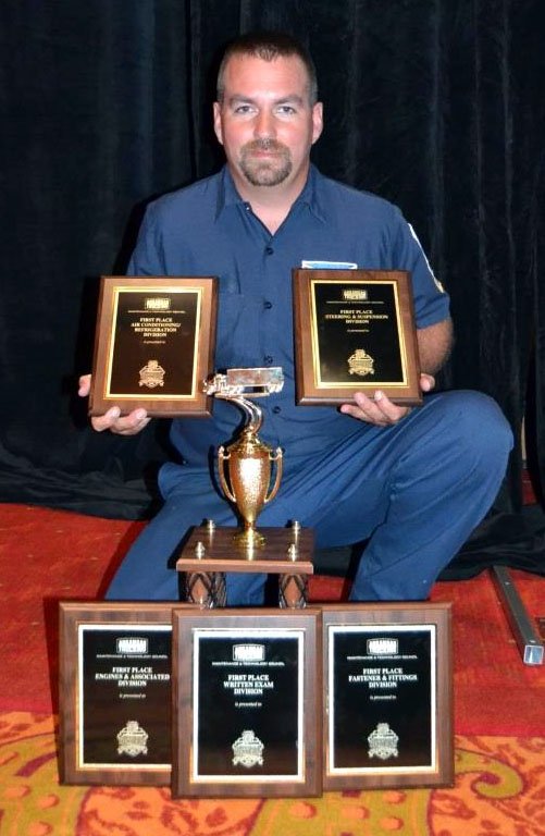 Submitted Photo Eric Rusk, of McKee Foods Transportation, poses with the plaques he earned as a top scorer in each competition category and his runner-up trophy for earning the second best score in the overall competition.