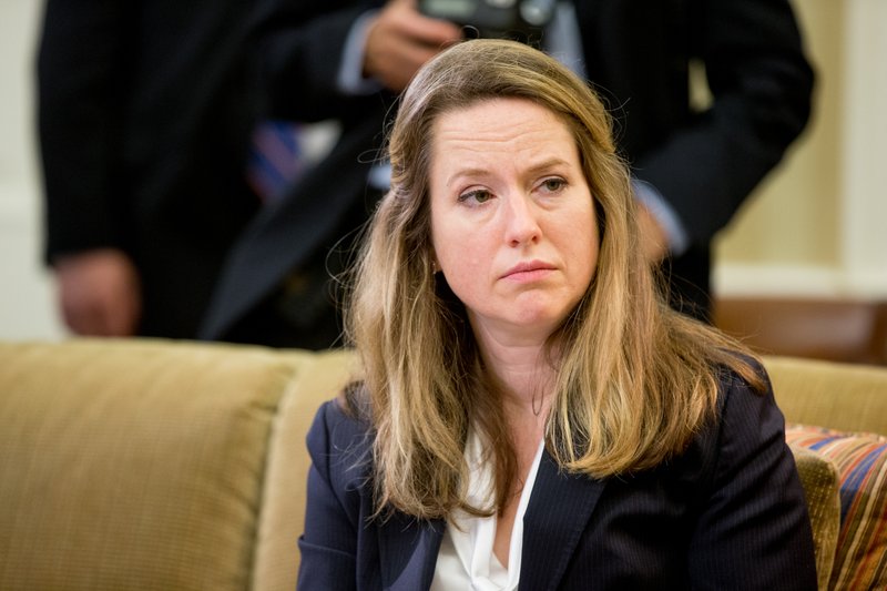 In this photo taken May 20, 2016, Deputy Homeland Security Adviser Amy Pope listens as President Barack Obama speaks in the Oval Office at the White House in Washington.