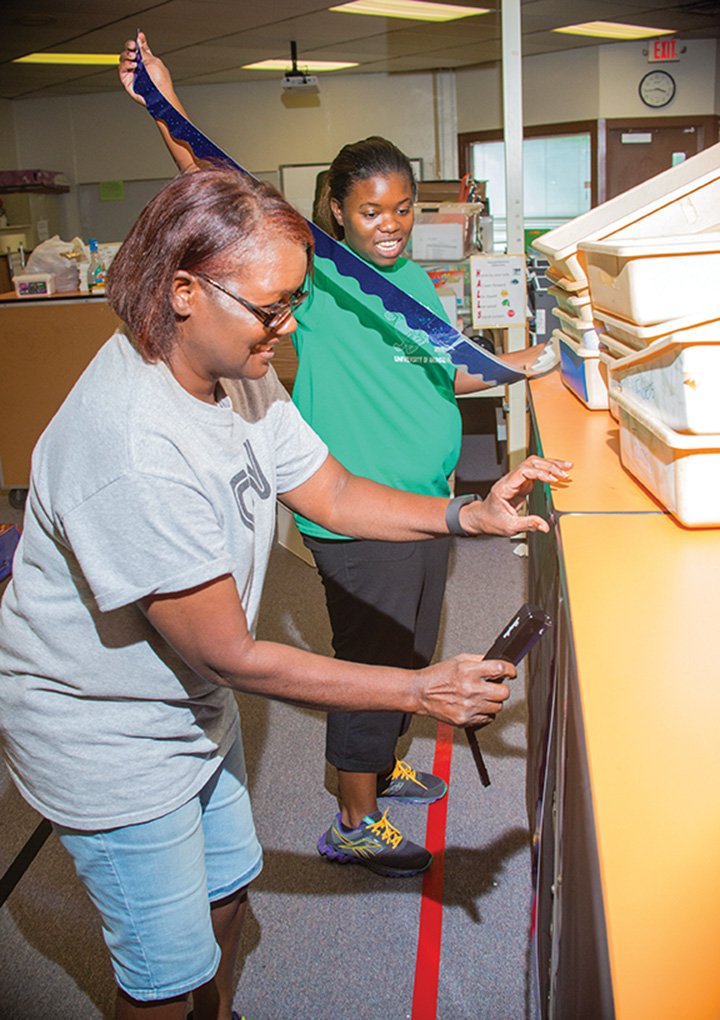 Wanda Jackson, left, helps her daughter Kelsea Jackson, a third-grade teacher at Pinewood Elementary School in Jacksonville, prepare her classroom for the upcoming school year, Kelsea’s first at Pinewood.