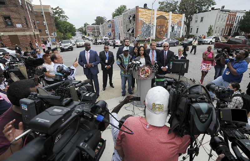 “We do not believe Freddie Gray killed himself,” Baltimore State’s Attorney Marilyn Mosby said Wednesday at a news conference near the site where Gray, depicted in the mural in the background, was arrested in April 2015.
