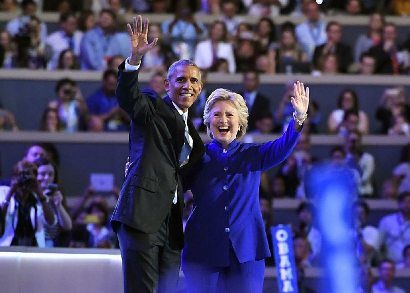 President Barack Obama is joined onstage after his speech Wednesday night by Democratic presidential nominee Hillary Clinton.