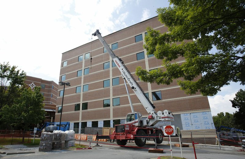 Work continues Wednesday on the expansion of Washington Regional Medical Center in Fayetteville. The $60 million project includes construction of a 100,000-square-foot, five-story tower on the west side of the campus, adjoining the Johnelle Hunt Women’s Center. It will also include additional operating room space, a larger neonatal intensive care unit, increasing from 12 to 34 beds, a new pediatrics space, more adult patient rooms, additional clinic space, a second helipad on top of the tower’s fifth floor, and a 350-space parking garage.