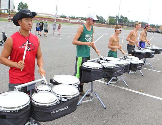 Drum line The Sentinel-Record/Richard Rasmussen From left, the Cavaliers Drum & Bugle Corps members Chad Raulston, of Dallas, Tyler Bogard of Indianapolis, Avery Melucci of Seminole, Fla., and Forrest Budway of Raleigh, N.C., rehearse at Lake Hamilton's Bank of the Ozarks Field on Wednesday for a competition event in Little Rock. 