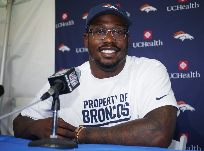 The Associated Press CHAMPS' CAMP: Denver outside linebacker Von Miller listens to a question during a news conference before the team's opening of training camp Wednesday in Englewood, Colo. A star in the Broncos' Super Bowl 50 triumph over the Carolina Panthers, Miller signed a new contract in the offseason.