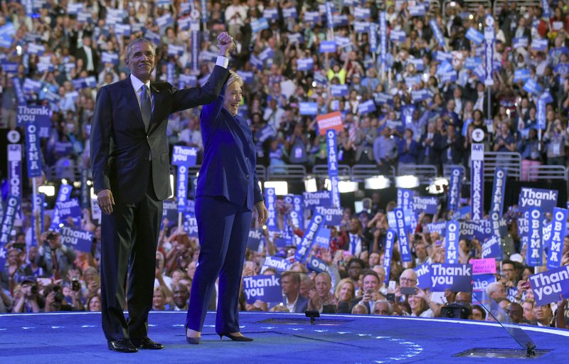 President Barack Obama, right, and Democratic presidential candidate Hillary Clinton, left, wave to the crowd following Obama's speech at the Democratic National Convention in Philadelphia, Wednesday, July 27, 2016. (AP Photo/Susan Walsh)
