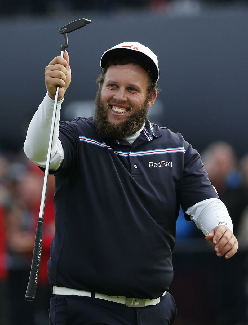 Andrew Johnston, a.k.a. Beef, of England raises his club as he acknowledges the crowd on the 18th green during the final round of the British Open Golf Championship at the Royal Troon Golf Club in Troon, Scotland, Sunday, July 17, 2016. 