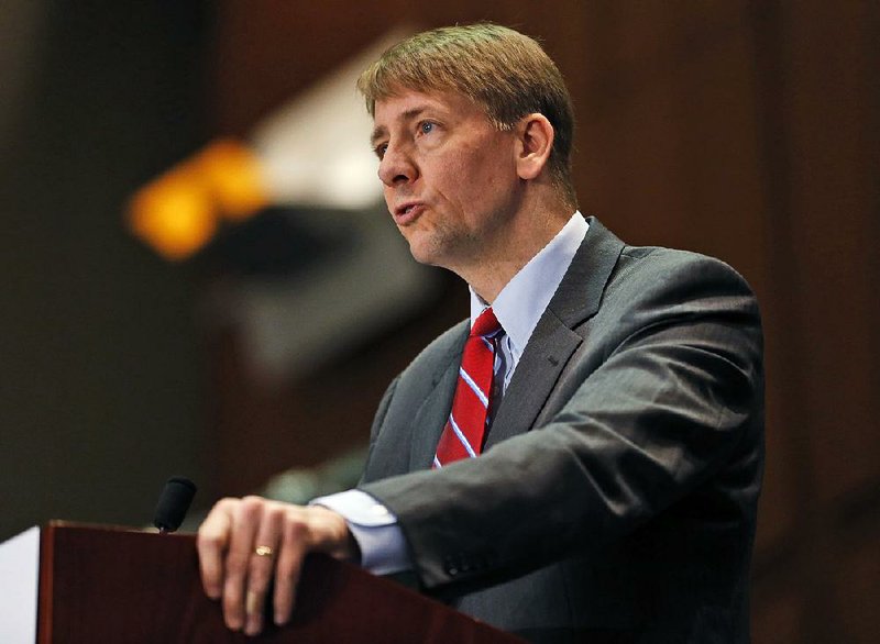 In this March 26, 2015, file photo, Consumer Financial Protection Bureau Director Richard Cordray speaks during a panel discussion in Richmond, Va. 