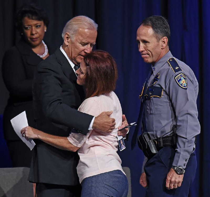 Vice President Joe Biden hugs Dechia Gerald, widow of officer Matthew Gerald, during Thursday’s service in Baton Rouge. Attorney General Loretta Lynch (left) and Baton Rouge Police Chief Carl Dabadie also were on hand.