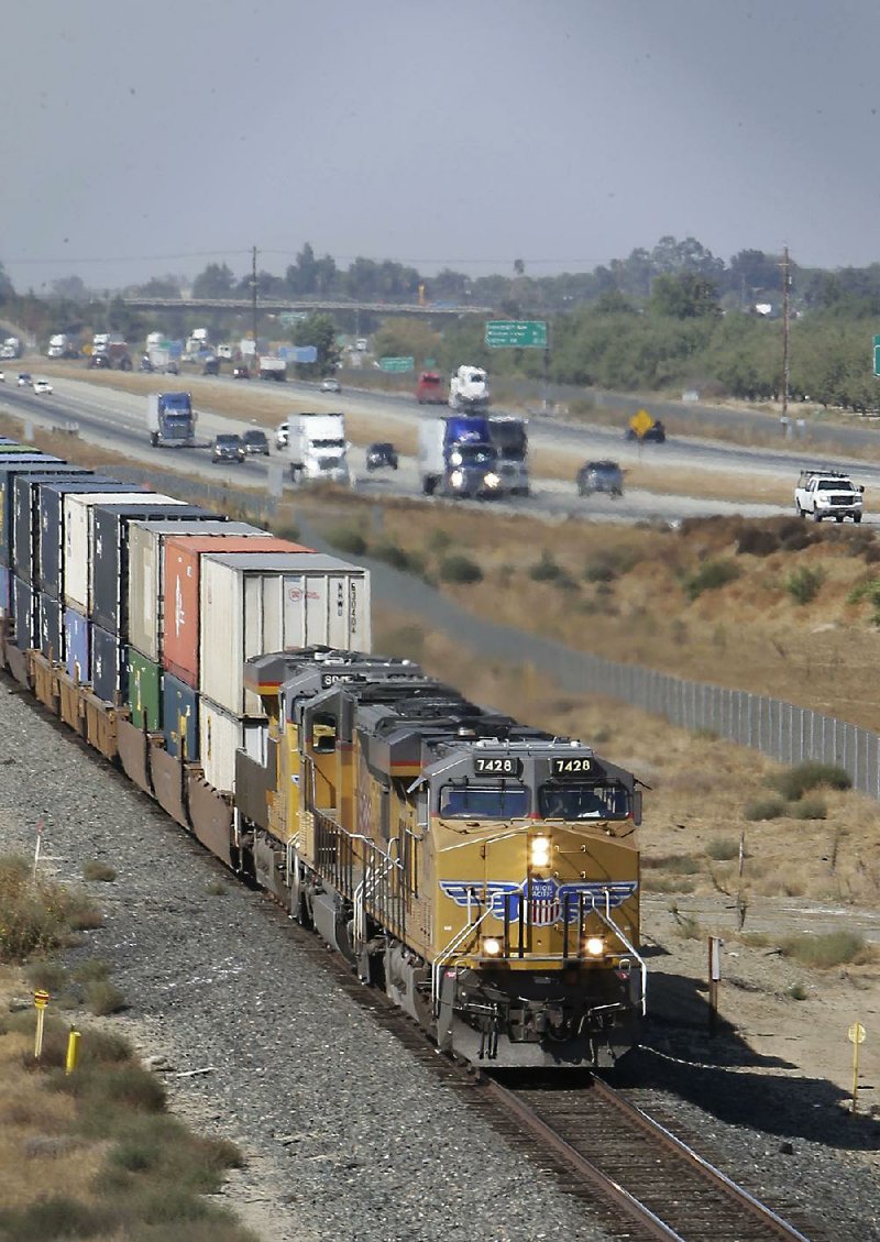 A freight train rolls south along U.S. 99 near Livingston, Calif., in this file photo. A rule proposed this week could force U.S. railroads to share their tracks with competitors under certain conditions.