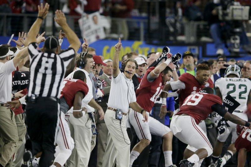 FILE - In this Dec. 31, 2015, file photo, Alabama head coach Nick Saban and his team take the field at the end of the Cotton Bowl NCAA college football semifinal playoff game against Michigan State, in Arlington, Texas. The College Football Playoff has abandoned a plan to play its semifinals on most New Year's Eves after television ratings tumbled last year, moving the dates of future games to ensure they will be played either on a Saturday or a holiday.
The changes will start with the 2018 season. (AP Photo/LM Otero, File)