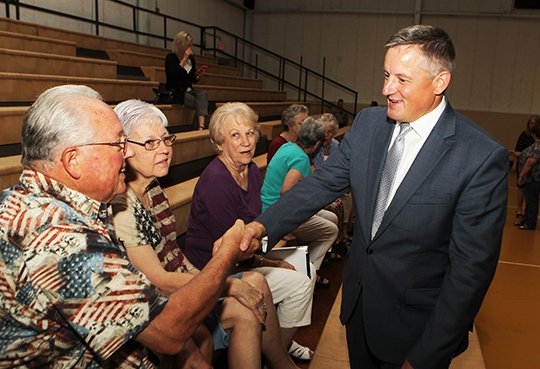 The Sentinel-Record/Richard Rasmussen WAGE BENEFITS: U.S. Rep Bruce Westerman, right, shakes hands with Tracy Coleman, left, with, from left, Judy Coleman and Bobbie Wilson Thursday in the National Park College Wellness Center gym. Westerman was invited to be a special guest speaker for the W.A.G.E. program's advisory committee meeting.