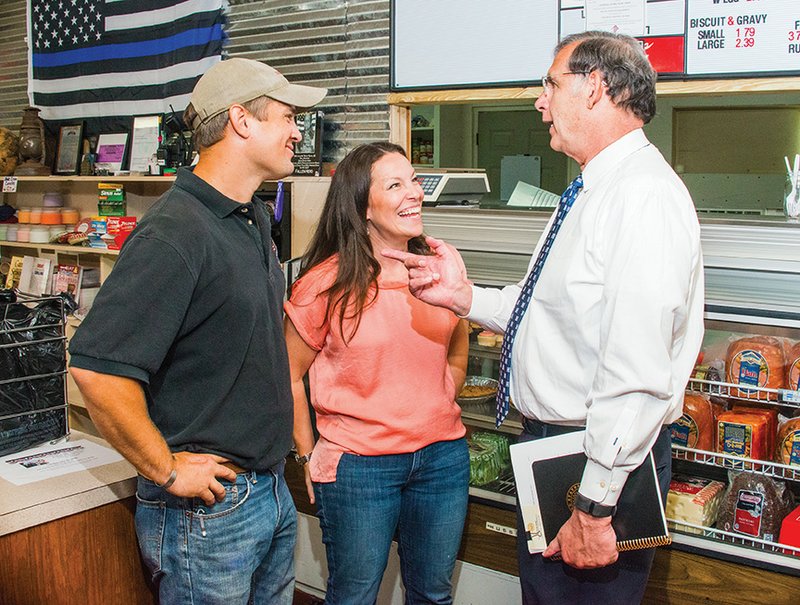 Damon and Jana Helton visit with U.S. Sen. John Boozman, R-Ark., during his visit Tuesday to the Olde Crow General Store, which the couple operate in the Crows community in Saline County. The Heltons have utilized several programs to help educate them about farming, including Armed to Farm, which provides sustainable agriculture training for veterans, and about operating their own business, where they sell fresh meat, produce and products from other local vendors.
