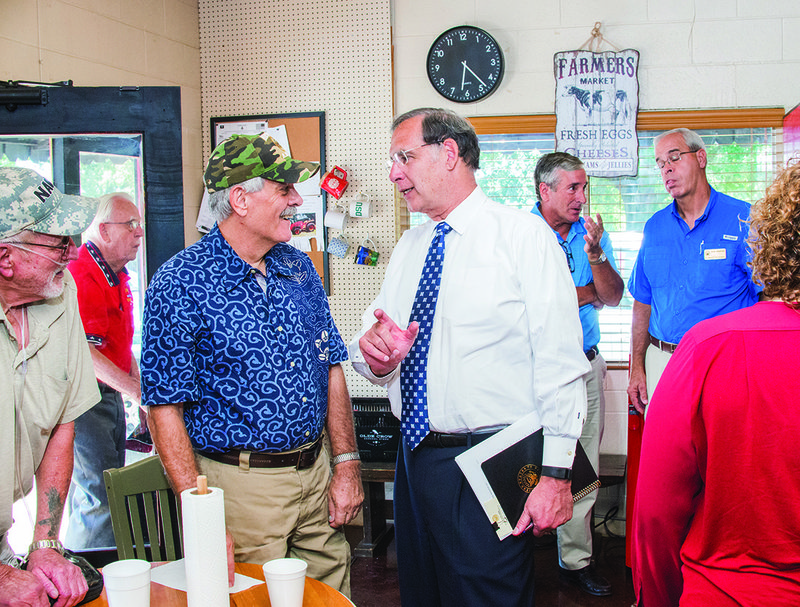 Ron Helton, father to the owner of Olde Crow General Store, talks to Sen. John Boozman as he visits the store in Saline County.