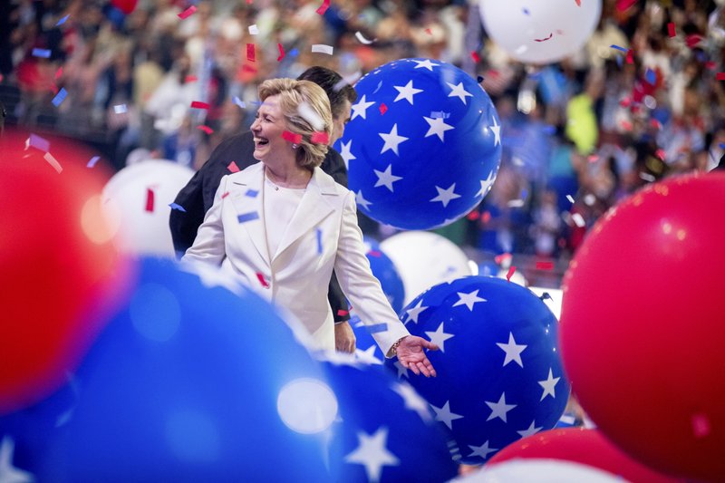 Democratic presidential candidate Hillary Clinton reacts to confetti and balloons as she stands on stage during the final day of the Democratic National Convention in Philadelphia, Thursday, July 28, 2016. (AP Photo/Andrew Harnik)
