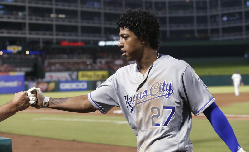 Kansas City Royals' Raul Mondesi is congratulated after his groundout that scored Alex Gordon during the fifth inning of Thursday’s game against the Texas Rangers in Arlington, Texas. 