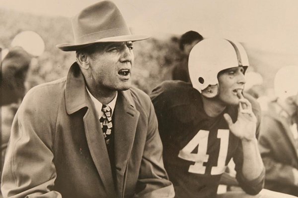 Arkansas coach John Barnhill and an unidentified player watch a game in 1949. (Arkansas Democrat-Gazette File)