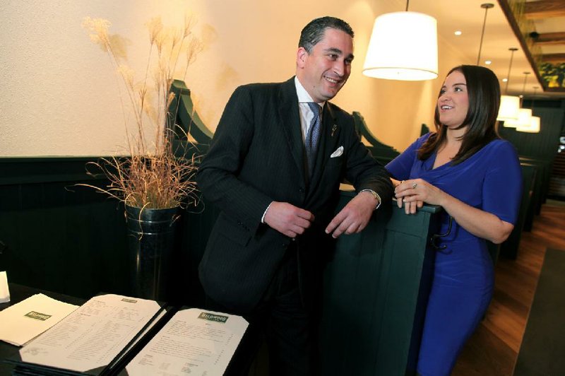 Adnane Kebaier (left), the maitre d’ at the Washington restaurant Marcel’s, ensures that guests are properly dressed.