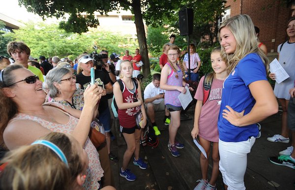 Arkansas pole vaulter and member of the US Olympics Team Lexi Weeks (right) smiles Thursday, July 28, 2016, as she poses for photographs with young fans during a celebration for Razorbacks athletes who will be participating in the upcoming Olympics in Rio de Janeiro on the Fayetteville square. Seven current and former Arkansas track and field athletes who will represent the United States, Jamaica and South Africa were joined by several former Olympians with Arkansas ties.