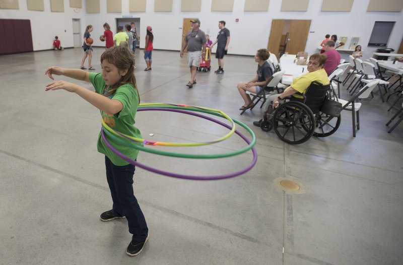 Reanna Dunlap, 11, of Hiwasse hula hoops July 24 during vacation Bible school at Holy Trinity Lutheran Church in Rogers.
