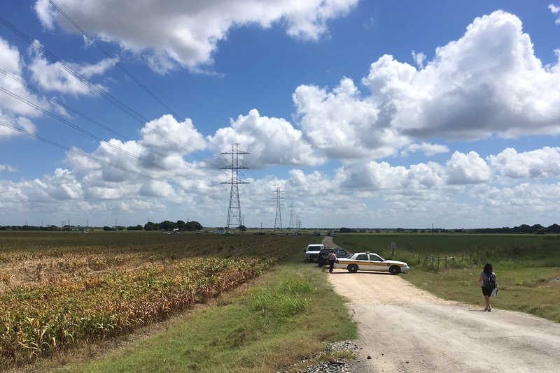 Police cars block access to the site where a hot air balloon crashed early Saturday near Lockhart, Texas. At least 16 people were on board the balloon, which Federal Aviation Administration spokesman Lynn Lunsford said caught fire before crashing into a pasture shortly after 7:40 a.m. No one appeared to survive the crash, authorities said. 