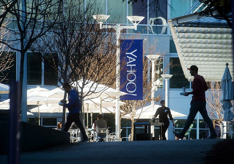 People walk between buildings on the Yahoo! Inc. headquarters corporate campus in Sunnyvale, Calif., earlier this year. 
