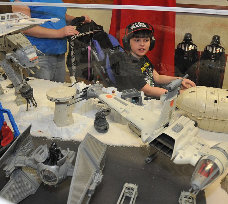 The Sentinel-Record/Mara Kuhn Seth McDaniel, 11, of Covington, Tenn., right, takes in the Galaxy Connection on Thursday. McDaniel, who is diagnosed with Ehlers-Danlos syndrome and Dysautonomia, was visiting the "Star Wars" and superhero-themed museum, located at 906 Hobson Ave., with his family as his Make-A-Wish selection. While in town, he and his family also planned to visit Tiny Town, the Maxwell Blade Theatre of Magic and Mid-America Science Museum.