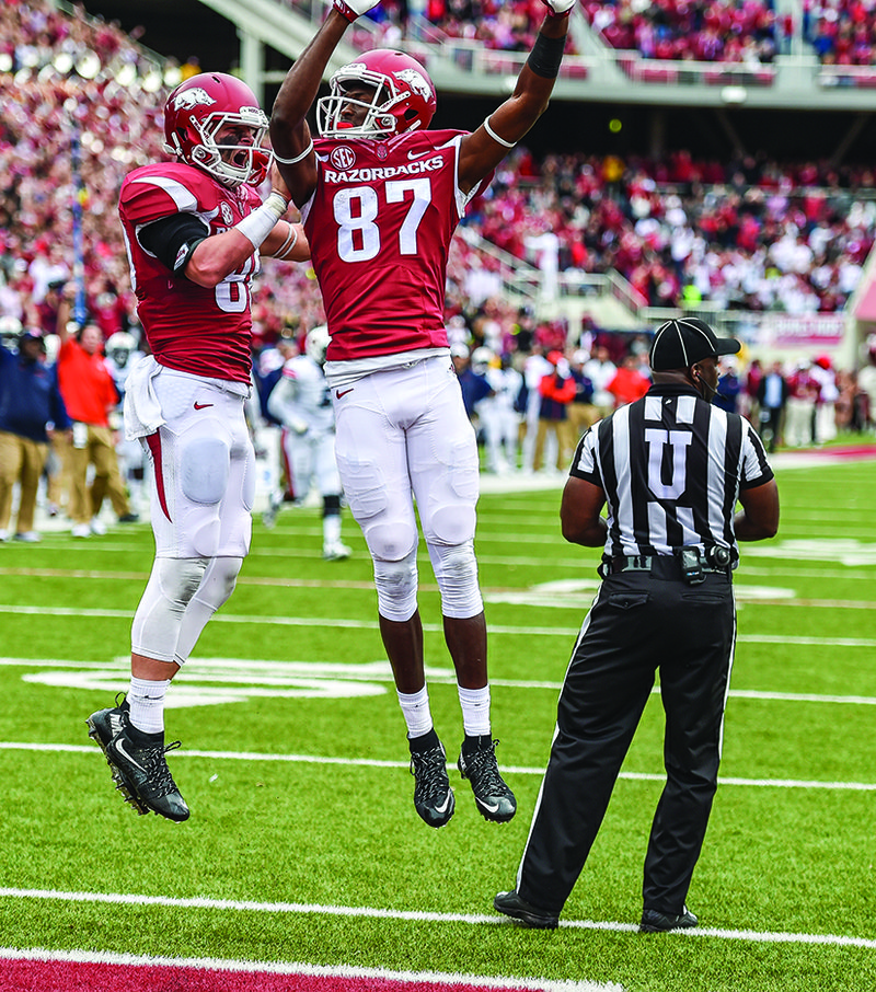 Arkansas' Dominique Reed (87) celebrates with teammate Drew Morgan after Morgan's touchdown against Auburn.