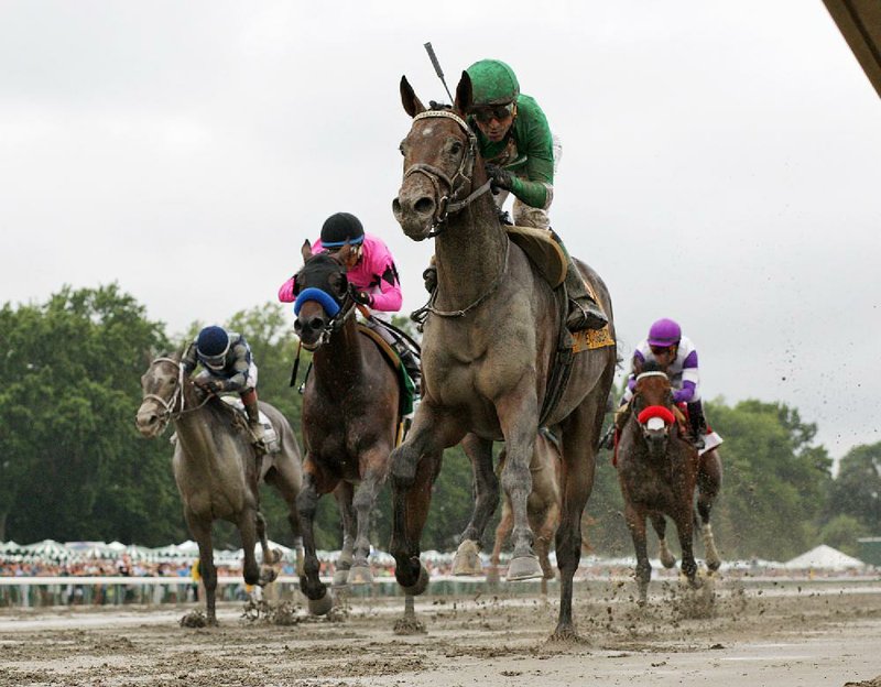 Exaggerator (front), ridden by Kent Desormeaux, outkicked a six-horse field, which included Kentucky Derby winner Nyquist, down the final stretch to win the $1 million Haskell Invitational on Sunday on a sloppy track at Monmouth Park in Oceanport, N.J.