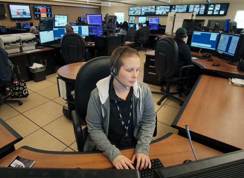 Taylor Krisell, a probationary 911 call taker, works at her station in the Communication Department in Little Rock on Friday.
