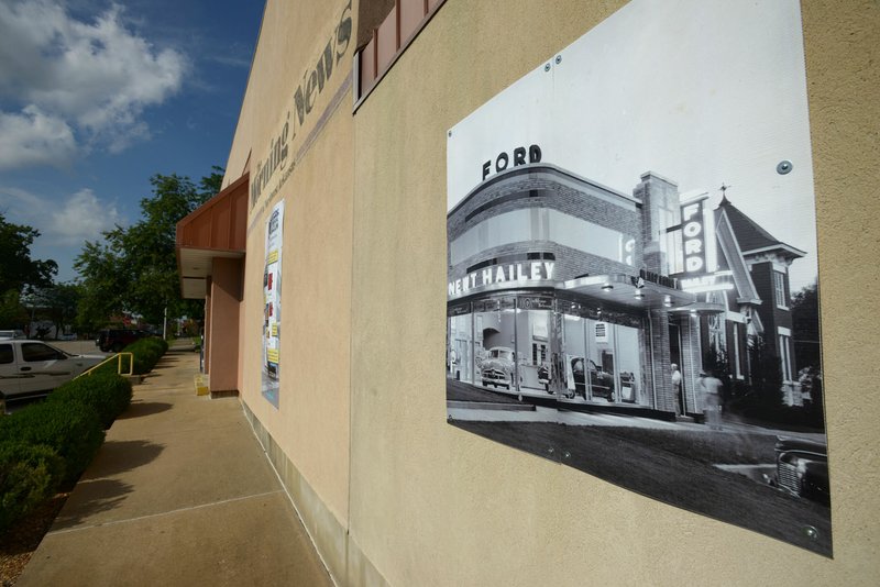 A photo hangs on the front of the former Rogers Morning News building showing the structure's origional appearance on Friday July 29, 2016 in downtown Rogers. 