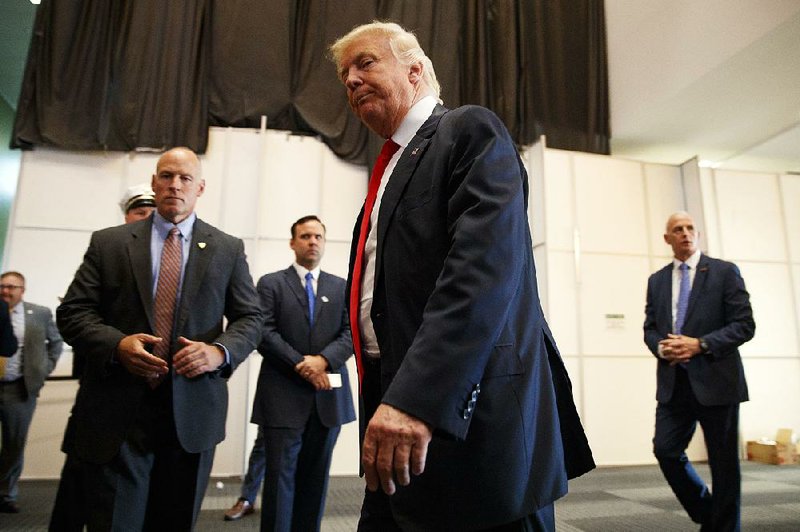 Republican presidential candidate Donald Trump walks away Monday after speaking to reporters before a town-hall event in Columbus, Ohio. Several Republican politicians denounced Trump’s comments about Khizr Khan’s speech at the Democratic National Convention.