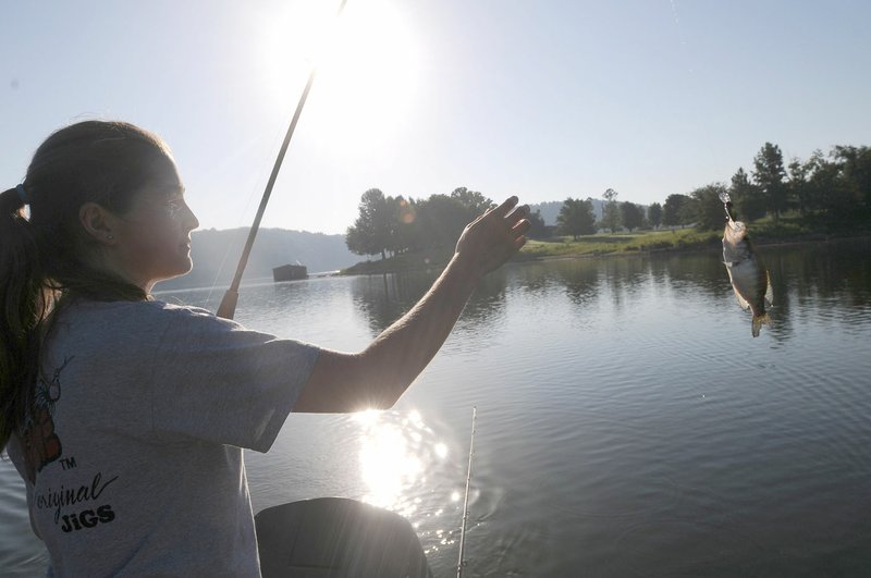 Tiffany Usrey lands a crappie she caught by trolling with crank baits.