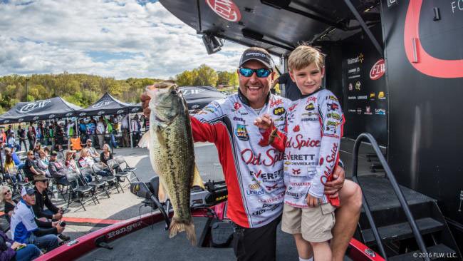 Greg Bohannan of Bentonville, with his son, Brock, weighs a largemouth bass at the Walmart FLW Tour event at Beaver Lake last April. He will fish in his fourth FLW championship, the Forrest Wood Cup, at Wheeler Lake in Alabama.