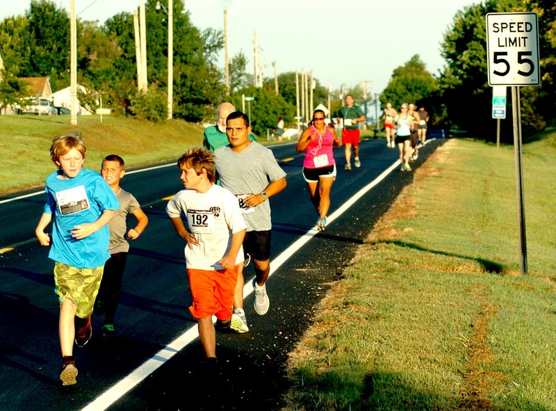 Photo by Mike Eckels Contestants in the 5K-10K ran along State Highway 102 during the Decatur Barbecue on Aug. 1, 2015. The 2016 event starts at 7 a.m. from the concession stands at Edmiston Park In Decatur.
