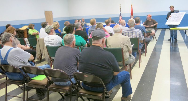 Photo by Susan Holland About 50 citizens attended an open public forum preceding last Thursday&#8217;s Gravette city council meeting. Questions were asked and comments made regarding the proposed Main Street improvement project. Gravette mayor, Kurt Maddox, refered to a display picturing the initial design plan to answer a question regarding the project.