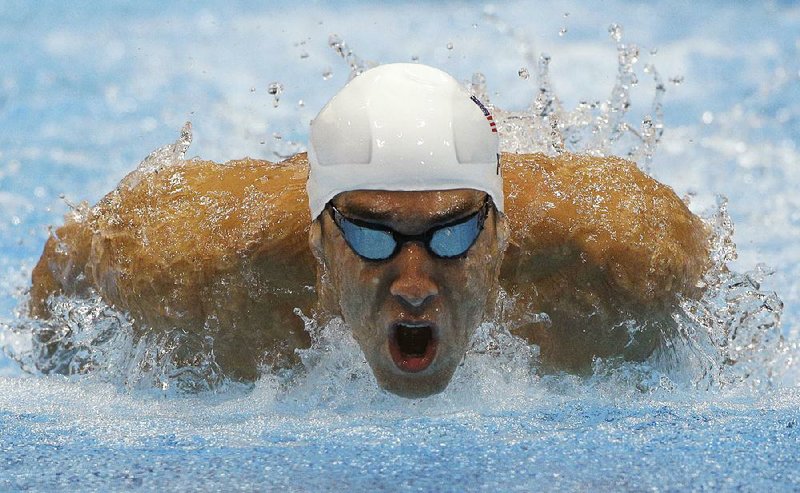 In this July 28, 2012, file photo, Michael Phelps competes in a heat of the men's 400-meter individual medley at the 2012 Summer Olympics in London. 