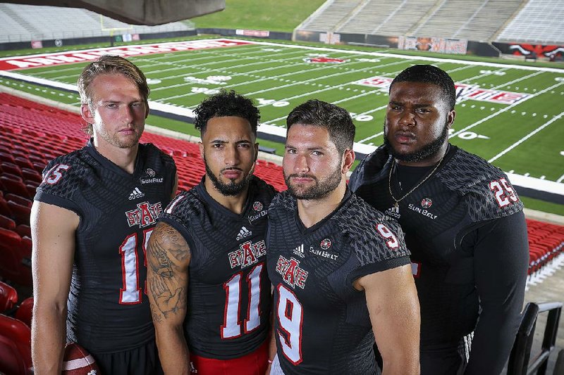 Arkansas State’s roster includes several players who started at Power Five schools, including (from left) quarterback Justice Hansen (Oklahoma), receiver Cameron Echols-Luper (TCU), quarterback Chad Voytik (Pittsburgh) and defensive lineman Dee Liner (Alabama). Another is receiver Kendall Sanders (Texas, not pictured).