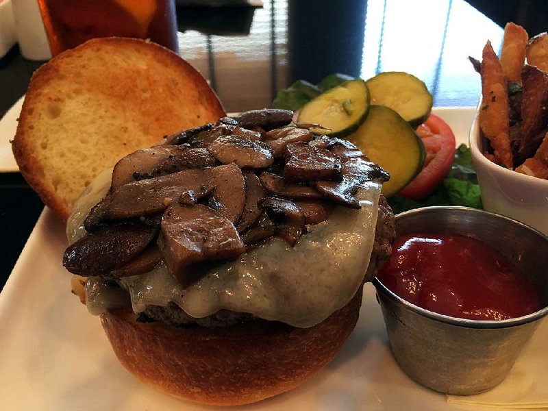 The Capital Bar & Grill’s Burger is a 7-ounce, ground-in-house, all-natural beef patty on a brioche bun; diners choose cheeses (in this case, Swiss) and toppings (sauteed mushrooms, bacon or caramelized onion). It comes with a side of parmesan fries.