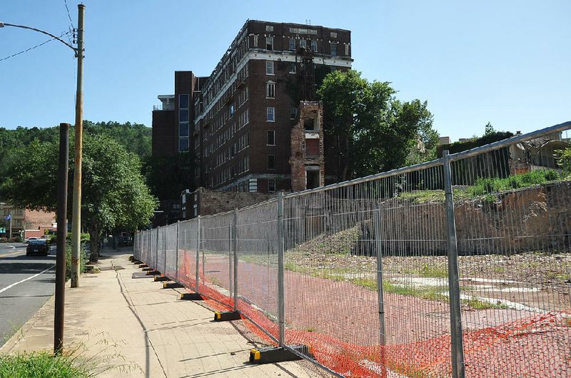 The Sentinel-Record/Mara Kuhn - A fence protects the sight of the Majestic Hotel from the public on Tuesday, Aug. 2, 2016.