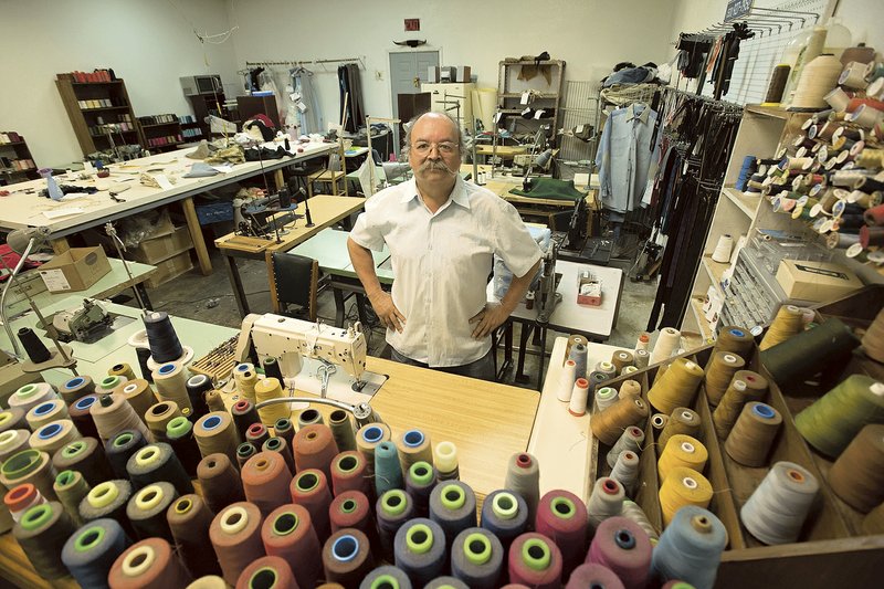 Javier Yanez stands among the many threads he uses in his Springdale alterations shop. Yanez said he’s ready to retire after 18 years, but the popular business will stay open.