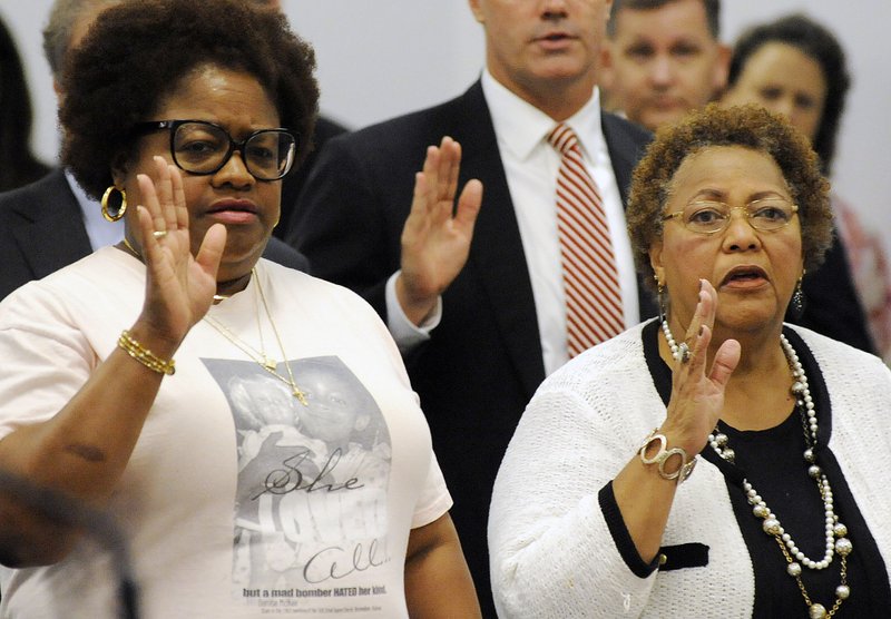 Lisa McNair, left, and Dianne Robertson Braddock are sworn-in before speaking to Alabama's parole board about the possible release of convicted church bomber Thomas Blanton Jr. in Montgomery, Ala., on Wednesday, Aug. 3, 2016. 