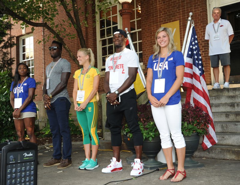 Olympians Chrishuna Williams (from left), Clive Pullen, Dominique Scott, Omar McLeod and Lexi Weeks smile Thursday, July 28, 2016, as they gather together during a celebration for Razorbacks athletes who will be participating in the upcoming Olympics in Rio de Janeiro on the Fayetteville square. Seven current and former Arkansas track and field athletes who will represent the United States, Jamaica and South Africa were joined by several former Olympians with Arkansas ties.