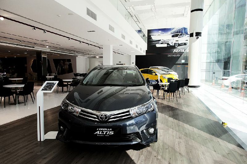 A Toyota Corolla Altis is displayed at a dealership in Singapore in July. Toyota on Thursday reported a second-quarter profit of $5.4 billion.