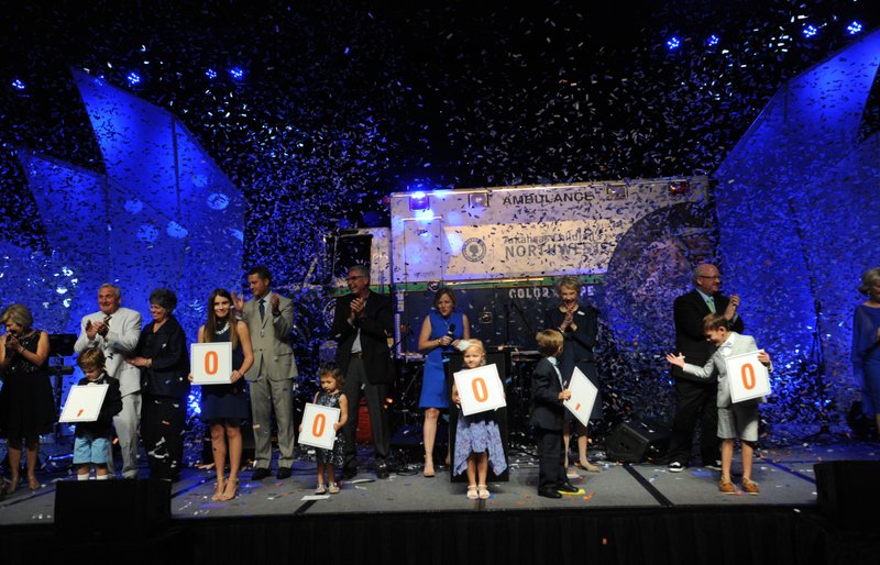 Marcy Doderer (center), president and CEO of Arkansas Children’s Hospital, announces Friday the start of the public capital campaign Care Close to Home: The Campaign for Arkansas Children’s Northwest as confetti falls during the 2016 Color of Hope Gala at the John Q. Hammons Center in Rogers. Doderer announced the campaign has raised $53 million so far.